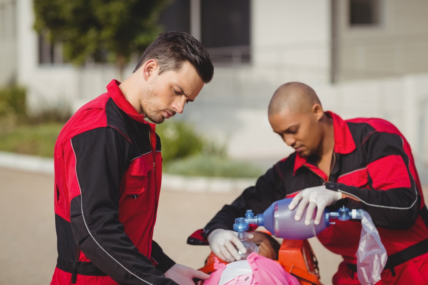 Two responders using a bag-valve mask during a BLS rescue scenario